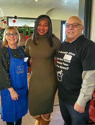 two women and a man posing for a picture