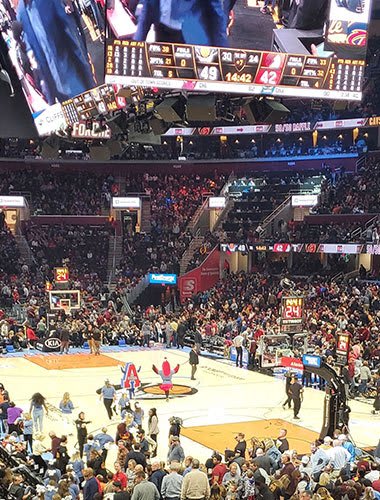 a crowd of people watching a basketball game in a stadium