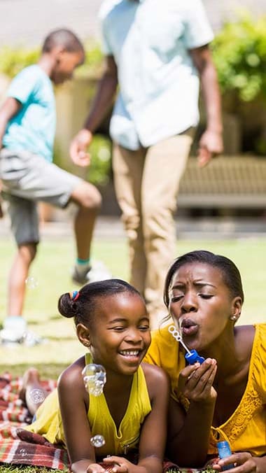 Lifestyle photo of mother and daughter blowing bubbles at Mission Bay Apartments, Florida 32955