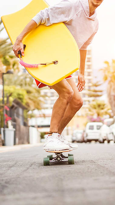 Man on skate board with surf board Hidden Cove Apartments in Miami Florida at Hidden Cove, Florida, 33169