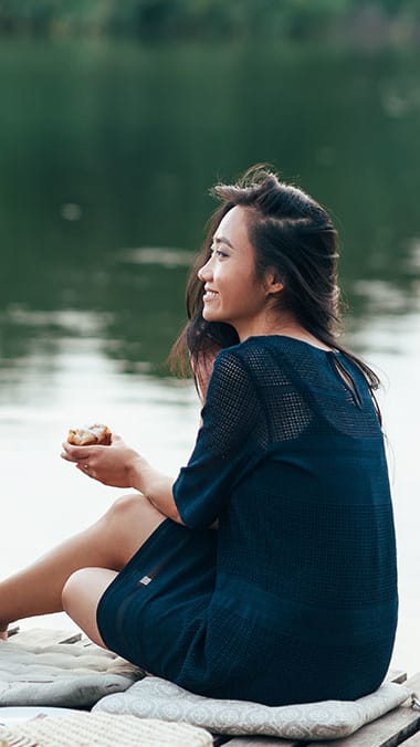 Woman sitting by the water at Hunters Run, Middleburg