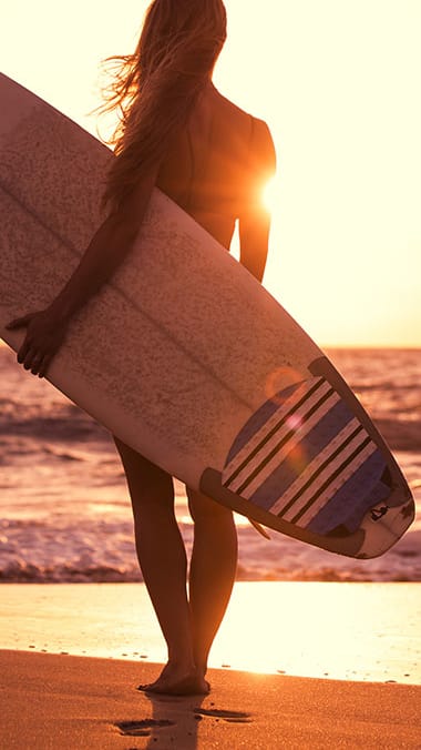 Woman holding a surf board at Hibiscus Pointe, Miami, FL 33147