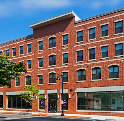 A red brick building with a black street light in front.