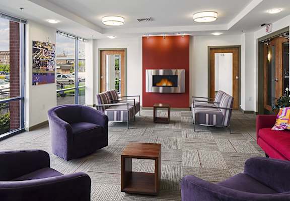 a living room with couches and chairs and a fireplace