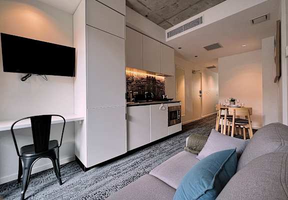 a small apartment with a kitchen and a living room