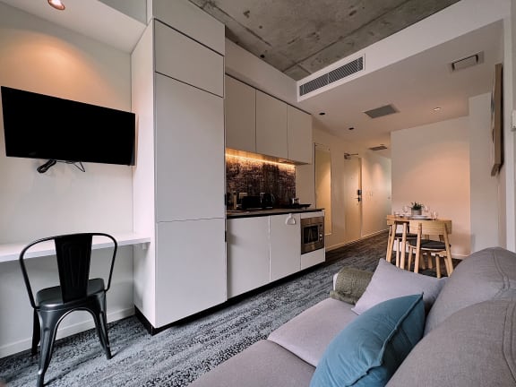 a small apartment with a kitchen and a living room