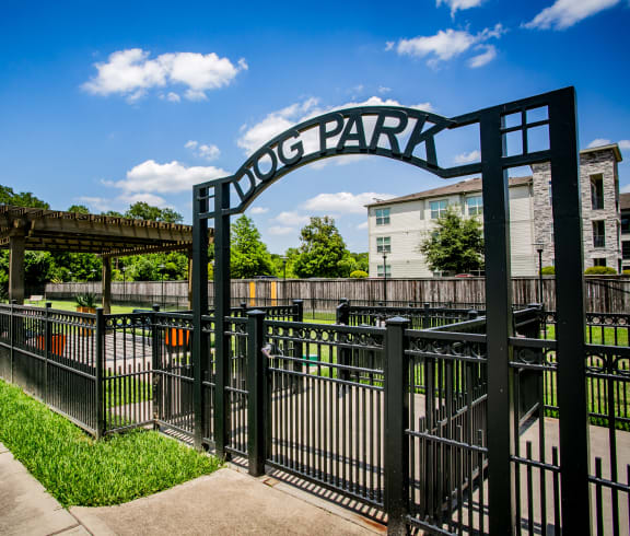 a park with a fence and archway with the words hong park written on it