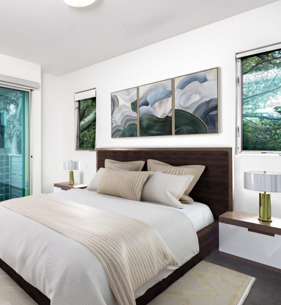 a bedroom with a bed and a sliding glass door