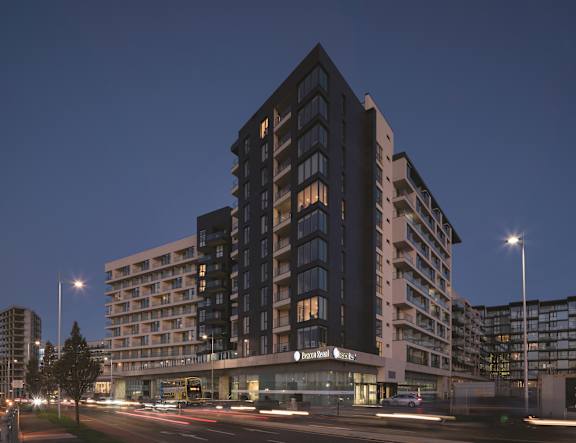 a tall building at night with street lights
