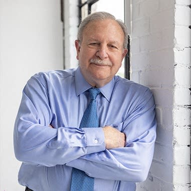 a man in a white shirt posing for a picture