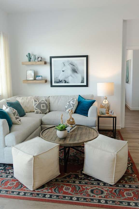 a living room with a white couch and a coffee table