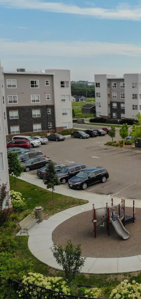 an aerial view of an apartment complex with cars in a parking lot