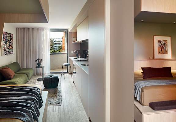 a hotel room with two beds and a kitchen