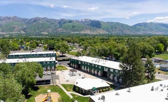an aerial view of a campus with mountains in the background