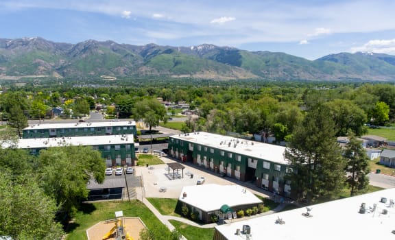 an aerial view of a campus with mountains in the background