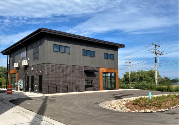 the front of a building with a blue sky in the background