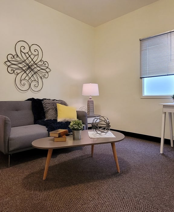 a living room with a couch and a desk with a chair