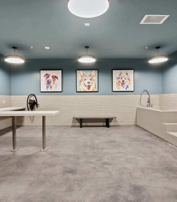 a living room with a gray couch and two round tables