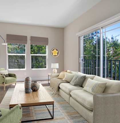 A living room with a green chair and a beige couch at Toluca Court, California