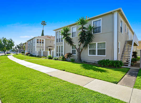 A row of houses with a clear blue sky above them.