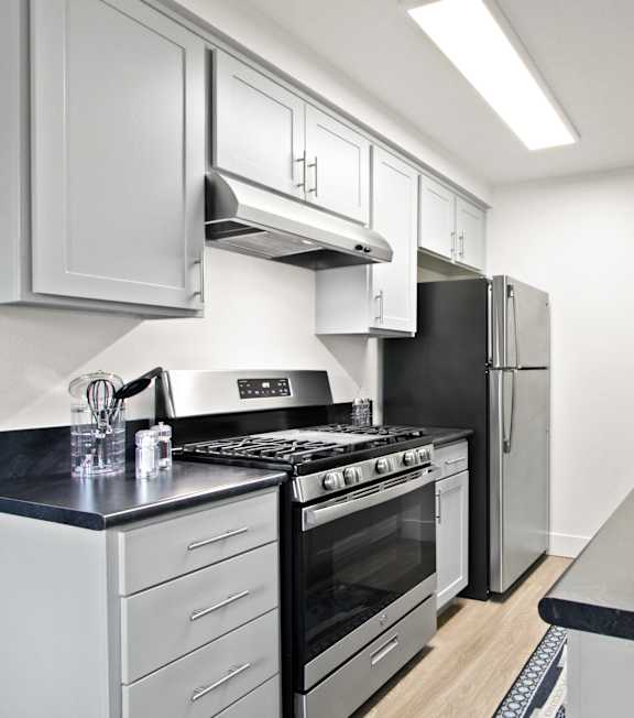 a kitchen with stainless steel appliances  at Clair Del and Clair Del Gardens, Long Beach, CA
