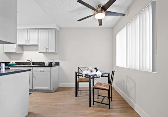 A kitchen with a table and chairs  at Clair Del and Clair Del Gardens, Long Beach, California