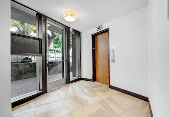 a living room with a large window and a door to a balcony