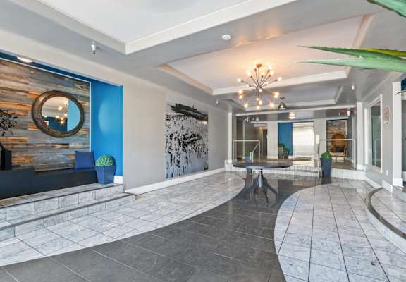 the lobby of a hotel with a table and a large window