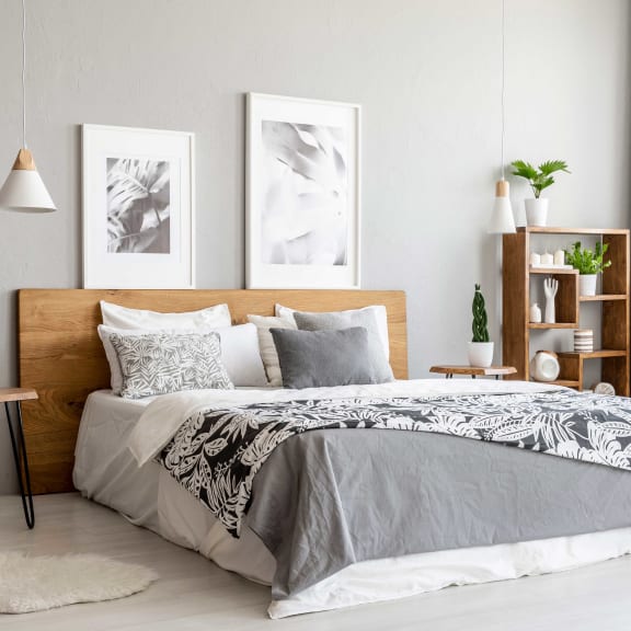 a bedroom with a bed and two pictures on the wall