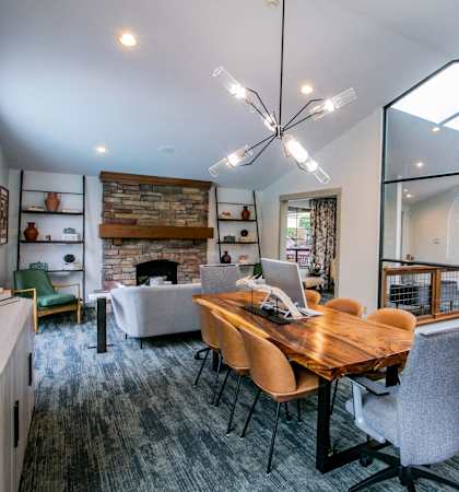 a dining room and living room with a table and chairs