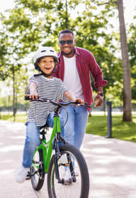 a man and a child riding a bike at Madison Rockwood, Ballwin, MO 63011