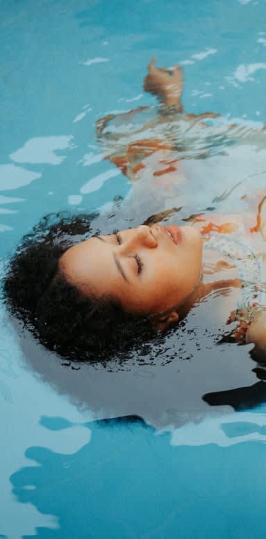 a young woman swimming in a pool at Zora Encanto, Phoenix, AZ