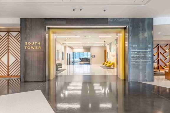 A hallway with a sign that says "South Tower" on the wall.
