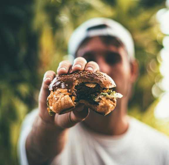 a man holding a sandwich in his hands