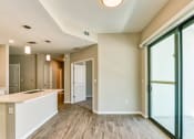 Thumbnail 4 of 49 - an open kitchen and living room with sliding glass doors at Imperial Crossing Luxury Apartment Homes, Bonita Springs, FL, 34134
