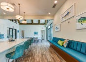 Thumbnail 30 of 49 - a living room with a kitchen and a blue couch at Imperial Crossing Luxury Apartment Homes, Bonita Springs