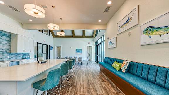 a living room with a kitchen and a blue couch at Imperial Crossing Luxury Apartment Homes, Bonita Springs