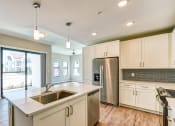 Thumbnail 2 of 49 - a kitchen with white cabinets and a stainless steel refrigerator at Imperial Crossing Luxury Apartment Homes, Bonita Springs, Florida