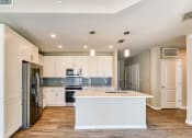 Thumbnail 5 of 49 - a renovated kitchen with white cabinets and a white counter top at Imperial Crossing Luxury Apartment Homes, Bonita Springs, FL
