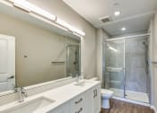 Thumbnail 6 of 49 - a bathroom with a shower and a sink and a mirror at Imperial Crossing Luxury Apartment Homes, Bonita Springs, FL, 34134