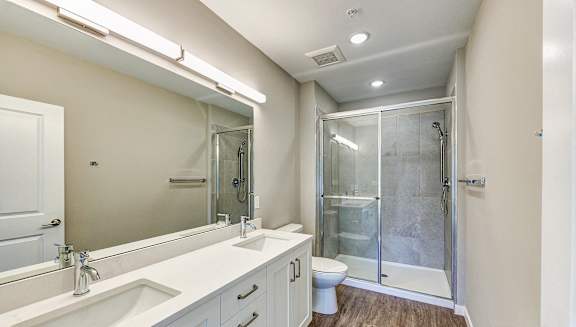 a bathroom with a shower and a sink and a mirror at Imperial Crossing Luxury Apartment Homes, Bonita Springs, FL, 34134