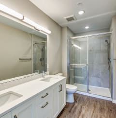 a gym with cardio machines and weights in a room with large windows  at Imperial Crossing Luxury Apartment Homes, Bonita Springs, FL, 34134