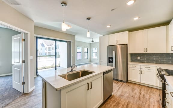 a large white kitchen with a dining area and a table  at Imperial Crossing Luxury Apartment Homes, Bonita Springs, FL, 34134