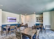 Thumbnail 36 of 49 - a dining room with tables and chairs and a large window at Imperial Crossing Luxury Apartment Homes, Florida