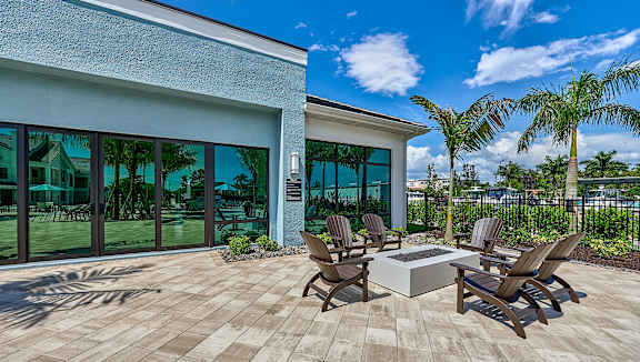 a patio with chairs and a fire pit at Imperial Crossing Luxury Apartment Homes, Florida