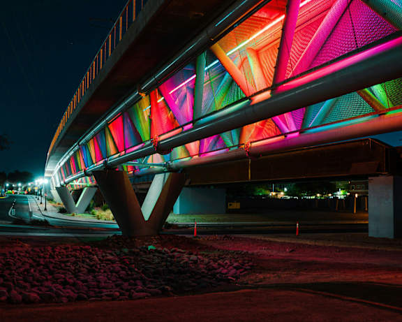 A bridge with a colorful lighting design on it.
