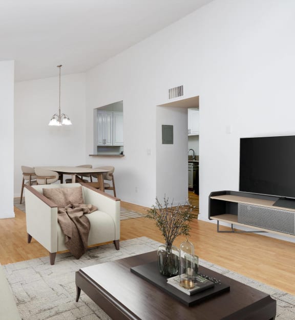an empty living room with wood floors and white walls