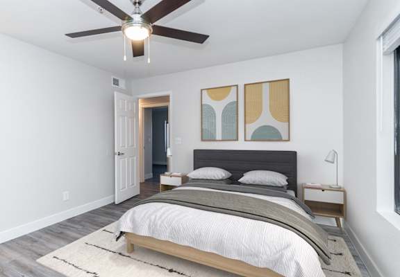 a bedroom with a large bed and a ceiling fan