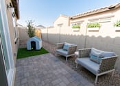 Thumbnail 3 of 4 - A patio with two chairs and a table.