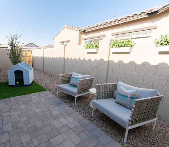 A patio with two chairs and a table.